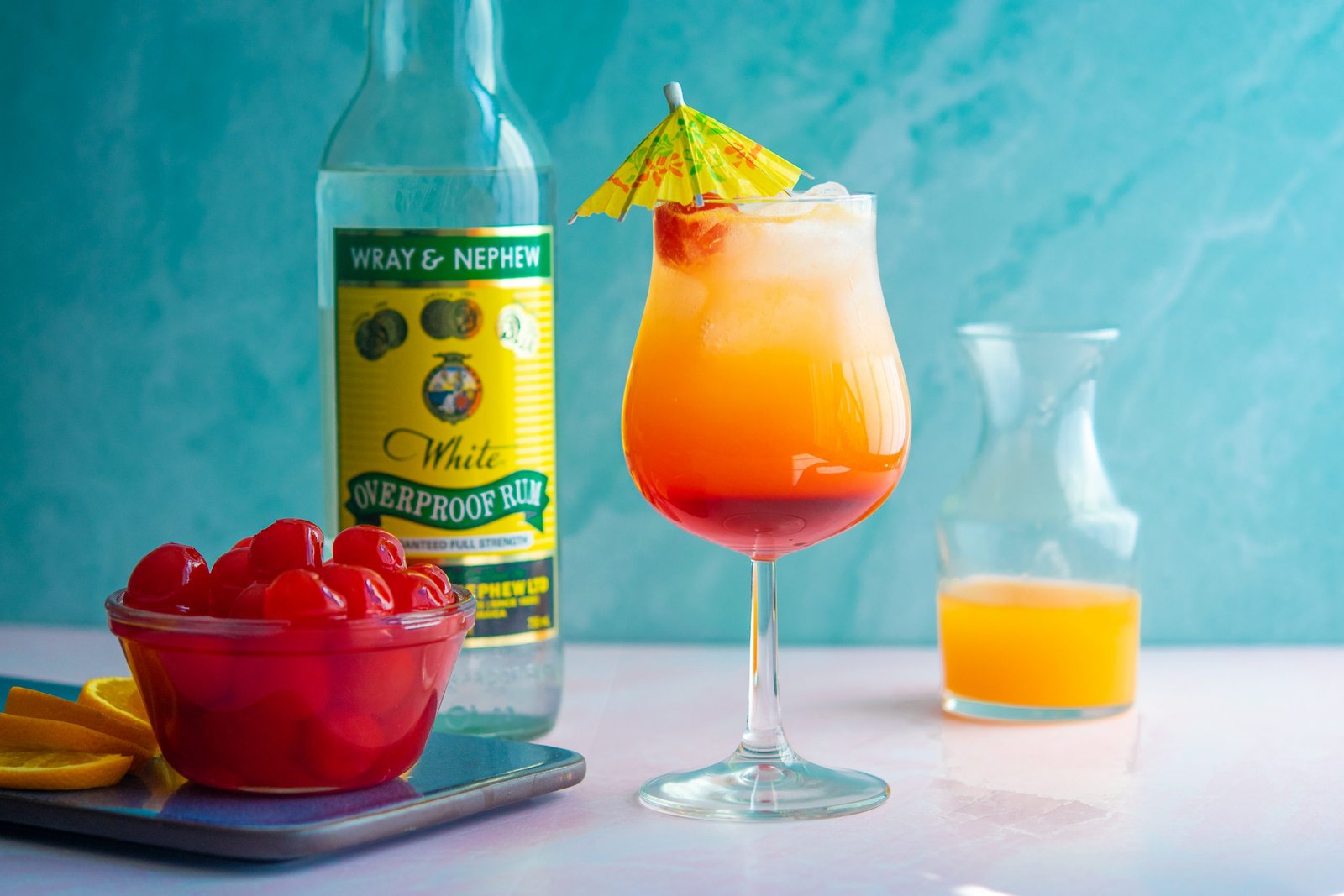 Rum cocktail beside a bottle of Jamaican rum