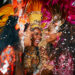 Ladies in vibrant Trinidad and Tobago Carnival costumes laughing and enjoying the festivities