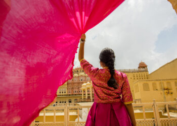 Woman inside the Hawa Mahal, also known as the Palace of the Wind, in Jaipur, Rajasthan, India.