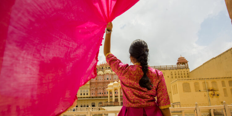 Woman inside the Hawa Mahal, also known as the Palace of the Wind, in Jaipur, Rajasthan, India.