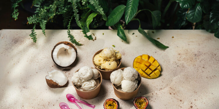 Bowls of tropical ice cream with coconut, mango, and passionfruit.