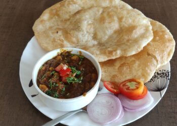 Chole bhature with chickpea curry and salad.