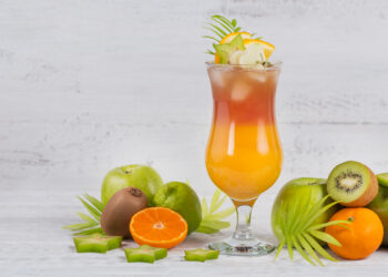 Tropical summer drink with fresh fruit garnish.