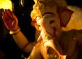 Idol of Lord Ganesha decorated with golden ornaments during Ganesh Chaturthi celebrations.