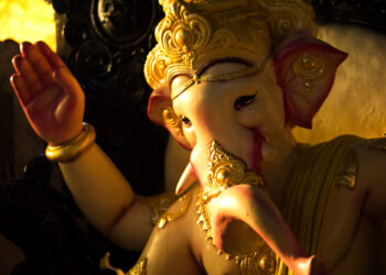 Idol of Lord Ganesha decorated with golden ornaments during Ganesh Chaturthi celebrations.