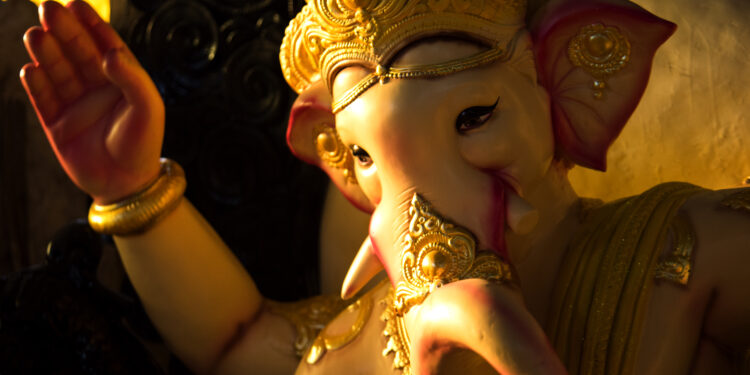 Idol of Lord Ganesha decorated with golden ornaments during Ganesh Chaturthi celebrations.