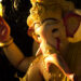 Idol of Lord Ganesha decorated with golden ornaments during Ganesh Chaturthi celebrations.