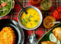 A traditional Navratri fasting meal featuring Indo-Caribbean vegetarian dishes such as pumpkin talkari, cassava stew, sabudana khichdi, and plantain chips, prepared for spiritual observance.