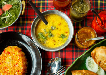 A flavorful Caribbean pelau dish served alongside a comforting Indian khichdi, showcasing the rich one-pot traditions of both cuisines.