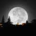 A glowing full moon over a calm Caribbean night sky, with a traditional bowl of kheer placed outdoors, symbolising the Indo-Caribbean celebration of Sharad Purnima.