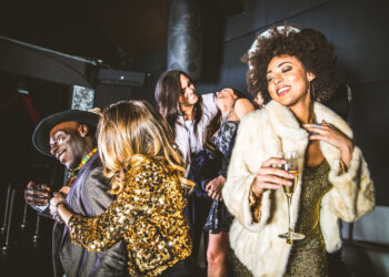 Dancers enjoying an autumn chutney soca and dancehall party in London, with colourful lights and Caribbean-Indian fusion vibes.