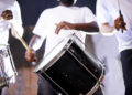 Musicians performing with tassa drums and dhol at an Indo-Caribbean cultural festival, blending Indian and Caribbean musical traditions.