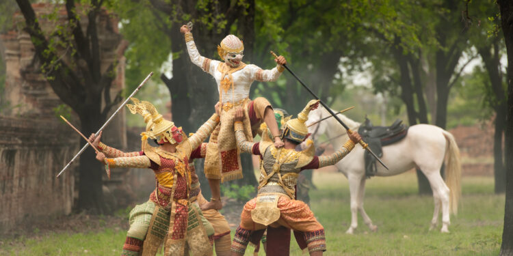 An elder sharing Indo-Caribbean folktales under warm evening light, surrounded by family, symbolising the fusion of Anansi stories and Indian epics in Caribbean culture.