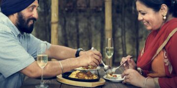 Langar meal being served at a gurdwara during Guru Gobind Singh Jayanti, with volunteers offering traditional Sikh food to seated devotees in a spirit of equality and service.
