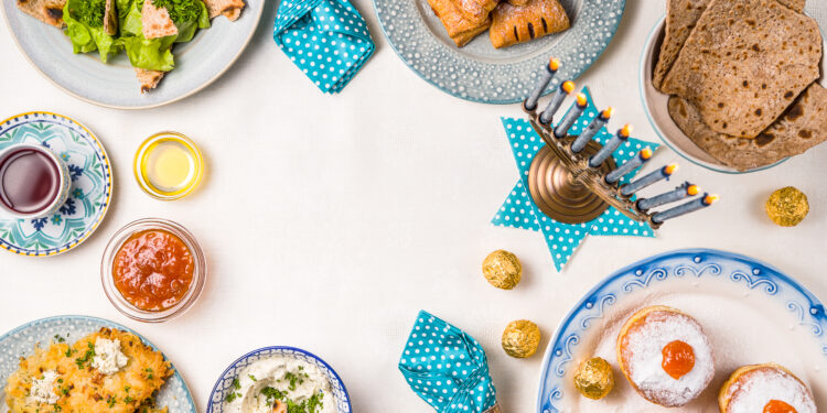An Indian festival feast laid out in a UK home with colourful curries, rice, breads, and traditional sweets arranged for a family celebration.