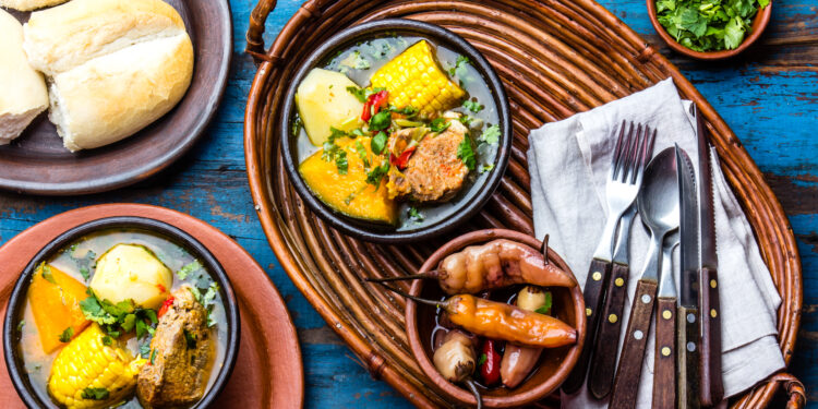 A steaming pot of Indo-Caribbean curry simmering on a stovetop during winter, filling the kitchen with warmth and spice.