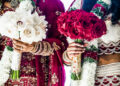 Vibrant Indo-Caribbean wedding celebration in the UK featuring colourful traditional outfits, floral décor, joyful family gatherings, and a lively dance floor blending cultural and modern elements.