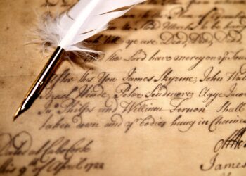 Museum exhibit in the Caribbean displaying historical photographs, ship records, and artefacts related to Indo-Caribbean indenture history and migration journeys.