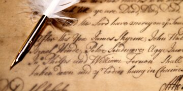 Museum exhibit in the Caribbean displaying historical photographs, ship records, and artefacts related to Indo-Caribbean indenture history and migration journeys.