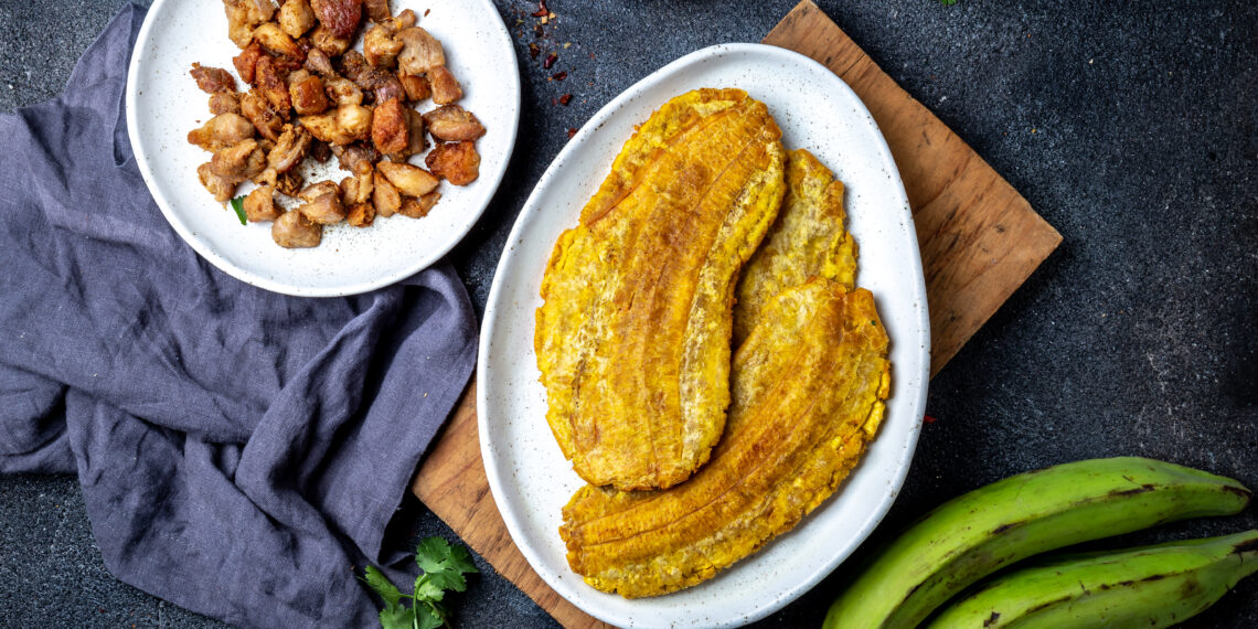 Trinidadian doubles filled with curried chickpeas and topped with tamarind chutney and cucumber, a classic Caribbean street food recipe served on soft fried bara.