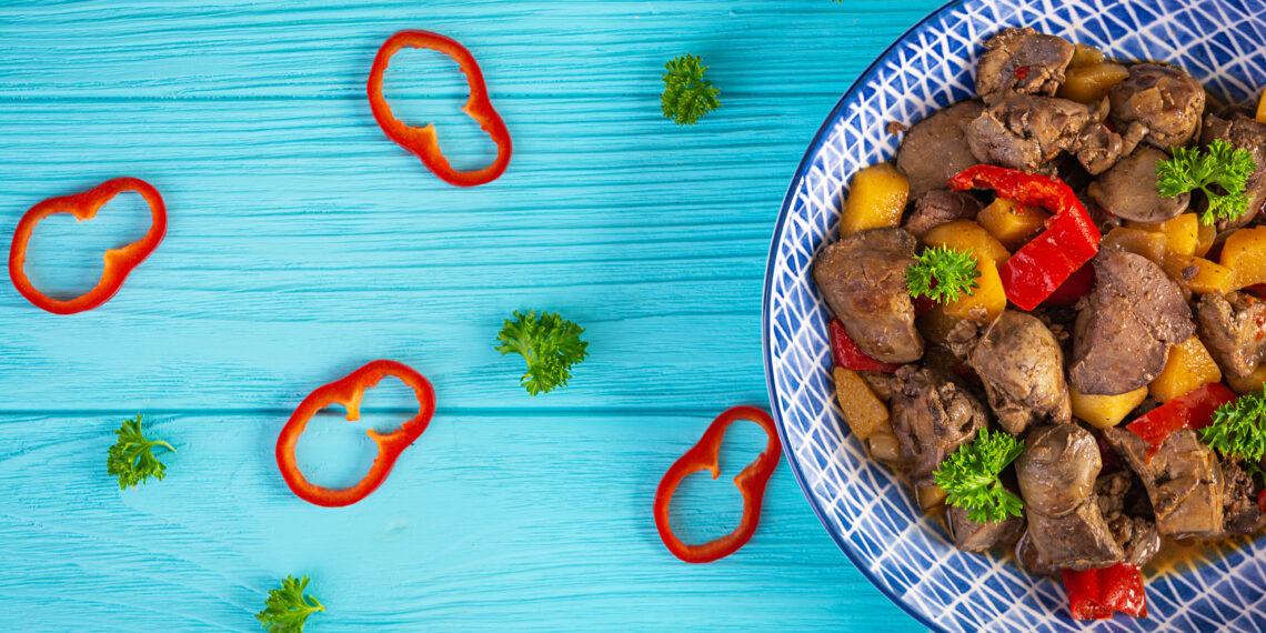 Traditional Guyanese pepperpot stew simmering with beef, cassareep, and Caribbean spices, a classic Caribbean Christmas food served with bread.