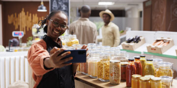 Bustling UK food market stall serving Caribbean, African and Asian street food with colourful dishes, spices, and customers enjoying global flavours.