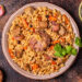Trinidad pelau rice with chicken, carrots and spices served in a bowl, a classic Caribbean one-pot meal