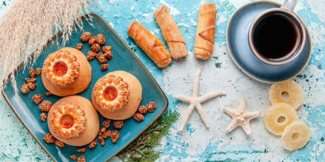 Assorted Indo-Caribbean desserts including coconut drops, sugar cakes and traditional mithai made with coconut, spices and brown sugar.